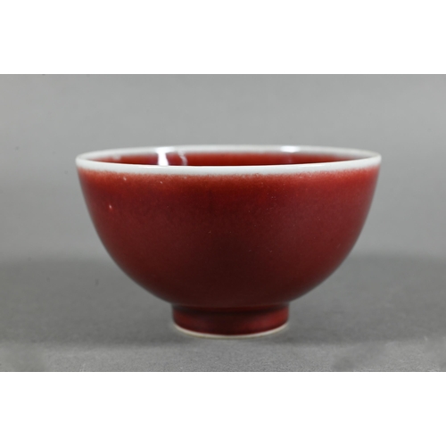 477 - A Chinese Lang Yao/sang-de-boeuf bowl, covered with a rich copper red glaze, contrasting white rim a... 