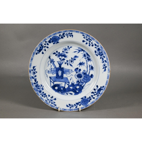 482 - A pair of 18th century Chinese blue and white plates, painted with a vase of flowers on a table in a... 