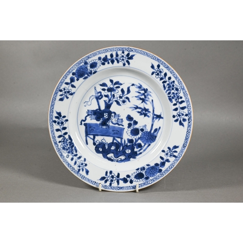 482 - A pair of 18th century Chinese blue and white plates, painted with a vase of flowers on a table in a... 