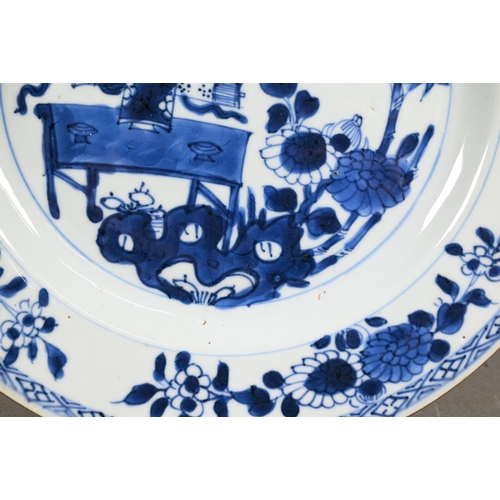 482 - A pair of 18th century Chinese blue and white plates, painted with a vase of flowers on a table in a... 