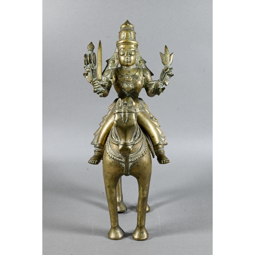 492 - An Indian brass figure of Khandoba (manifestation of Shiva) on the back of his horse, the four-armed... 