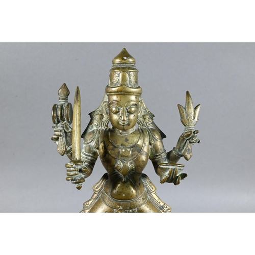 492 - An Indian brass figure of Khandoba (manifestation of Shiva) on the back of his horse, the four-armed... 