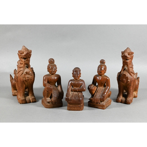 497 - A pair of South East Asian carved hardwood Buddhistic guardian lions, 15 cm high to/w a pair of knee... 