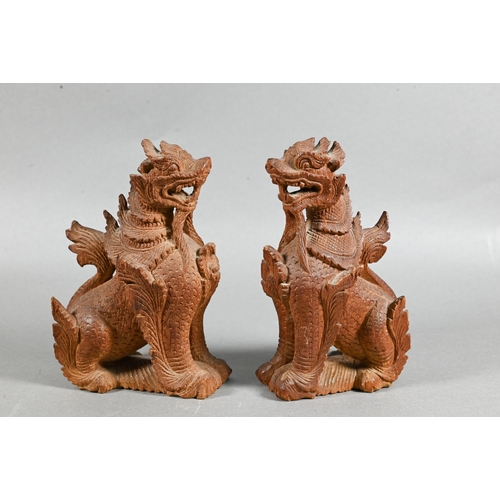 497 - A pair of South East Asian carved hardwood Buddhistic guardian lions, 15 cm high to/w a pair of knee... 