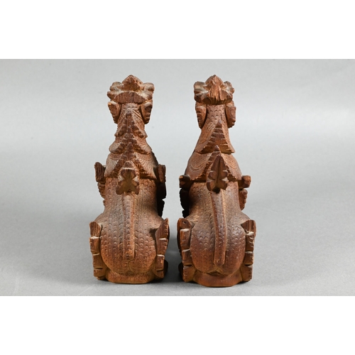 497 - A pair of South East Asian carved hardwood Buddhistic guardian lions, 15 cm high to/w a pair of knee... 