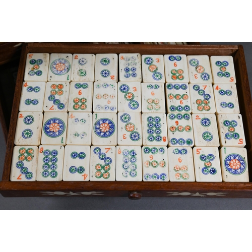 499 - A Chinese Mah Jong set, the hardwood and bone inlaid case with two carry handles and sliding front p... 