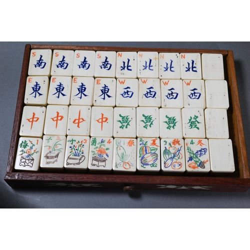 499 - A Chinese Mah Jong set, the hardwood and bone inlaid case with two carry handles and sliding front p... 