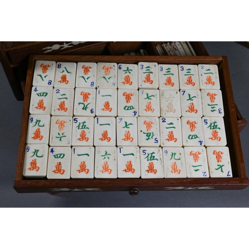 499 - A Chinese Mah Jong set, the hardwood and bone inlaid case with two carry handles and sliding front p... 