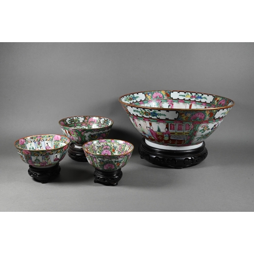 514 - A 20th century Chinese famille rose punch bowl painted with figures, flowers and birds in alternatin... 