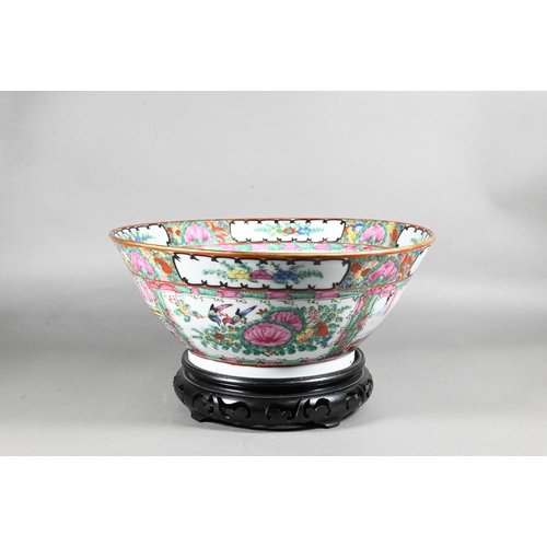 514 - A 20th century Chinese famille rose punch bowl painted with figures, flowers and birds in alternatin... 