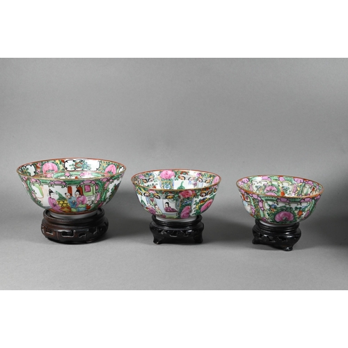 514 - A 20th century Chinese famille rose punch bowl painted with figures, flowers and birds in alternatin... 