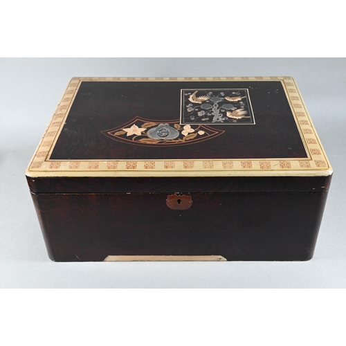 516 - An early 20th century Japanese black lacquered box with hinged cover decorated with birds and flower... 