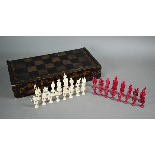 520 - A Chinese lacquer folding chessboard/backgammon board to/w a set of bone chessmen