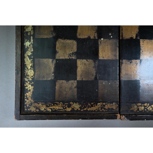 520 - A Chinese lacquer folding chessboard/backgammon board to/w a set of bone chessmen