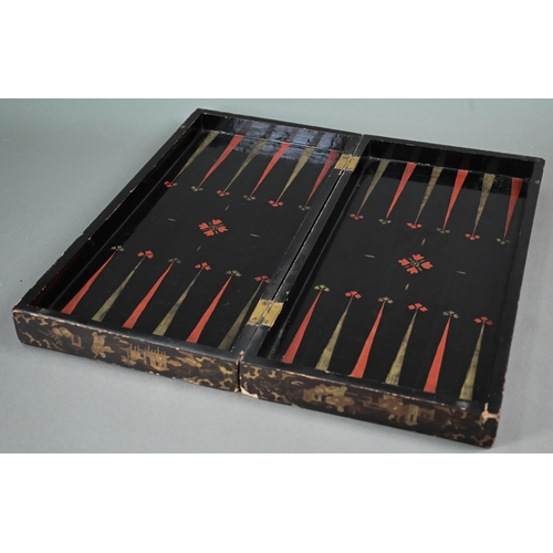 520 - A Chinese lacquer folding chessboard/backgammon board to/w a set of bone chessmen