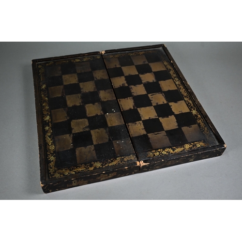 520 - A Chinese lacquer folding chessboard/backgammon board to/w a set of bone chessmen