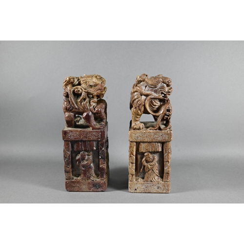 523 - A pair of Chinese carved soapstone block seals, surmounted by Kylin, 21 cm