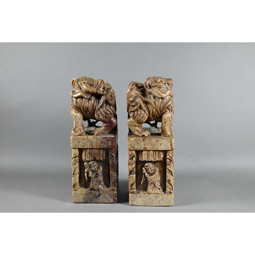 523 - A pair of Chinese carved soapstone block seals, surmounted by Kylin, 21 cm