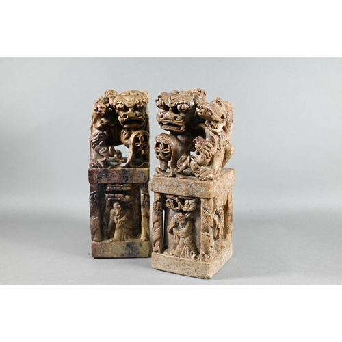 523 - A pair of Chinese carved soapstone block seals, surmounted by Kylin, 21 cm