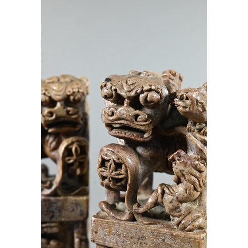 523 - A pair of Chinese carved soapstone block seals, surmounted by Kylin, 21 cm