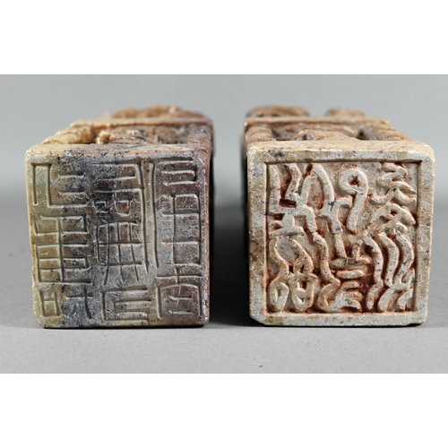 523 - A pair of Chinese carved soapstone block seals, surmounted by Kylin, 21 cm