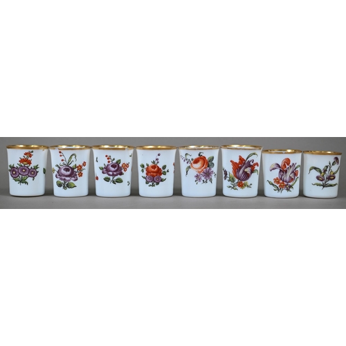 542 - A matched set of eight 19th century Continental opaque glass beakers, individually painted with flor... 