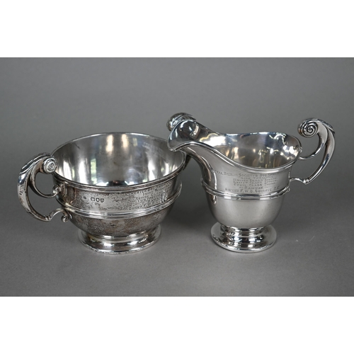 56 - A late Victorian silver milk jug and sugar basin with scroll handles, Goldsmiths and Silversmiths Co... 