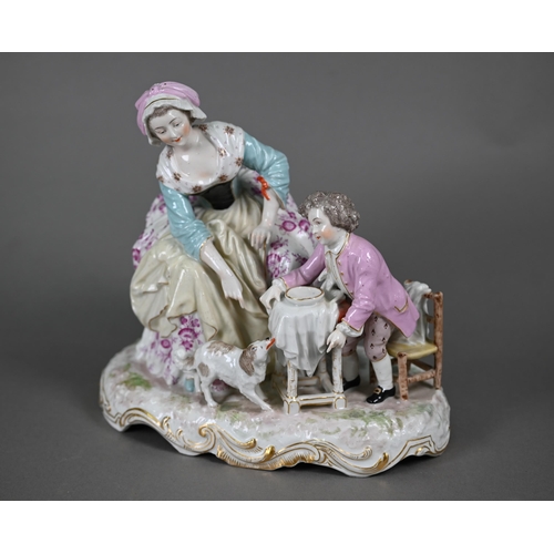 568 - A 19th century porcelain group, 18th century mother and child, the boy feeding scraps to a small dog... 