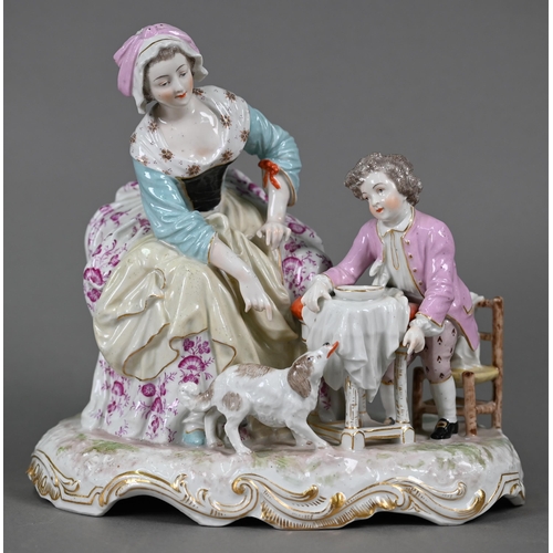 568 - A 19th century porcelain group, 18th century mother and child, the boy feeding scraps to a small dog... 