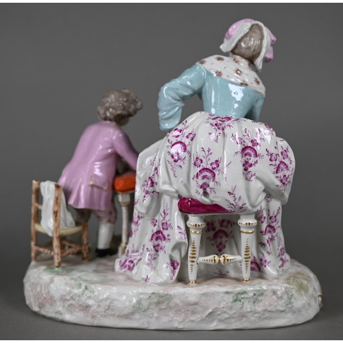 568 - A 19th century porcelain group, 18th century mother and child, the boy feeding scraps to a small dog... 