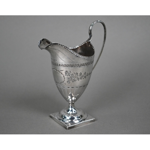 57 - A George III silver cream jug in the Adam taste, with engraved decoration, on stemmed square foot, S... 