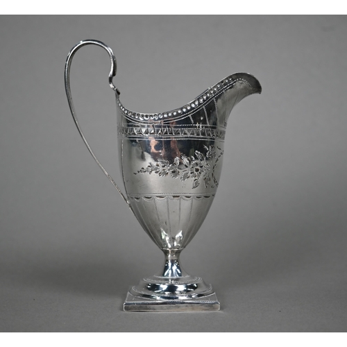 57 - A George III silver cream jug in the Adam taste, with engraved decoration, on stemmed square foot, S... 