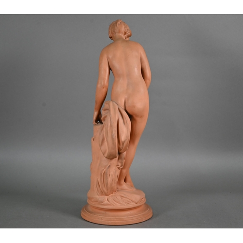 571 - A 19th century terracotta figure of a female nude, 42 cm on circular base (toe missing and chip on r... 