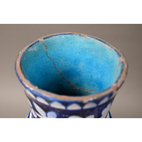 579 - A pair of antique Isnic ovoid vases with tapered neck and stemmed bases, painted with blue and white... 