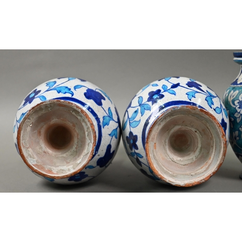 579 - A pair of antique Isnic ovoid vases with tapered neck and stemmed bases, painted with blue and white... 