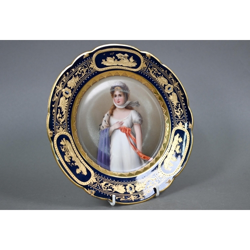 588 - A 19th century Vienna porcelain wall-plate painted with portraits of a lady, 'Luise', within a blue ... 