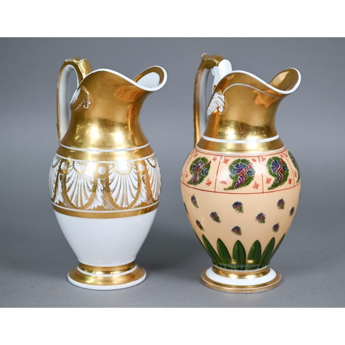 590 - Two Empire Period Paris porcelain gilded jugs of matching shape, with extensive gilding - one polych... 