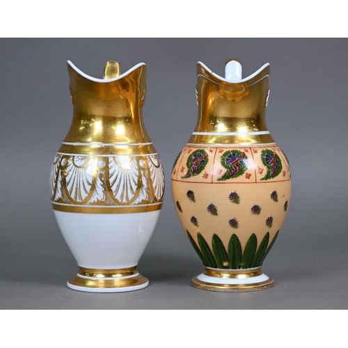 590 - Two Empire Period Paris porcelain gilded jugs of matching shape, with extensive gilding - one polych... 