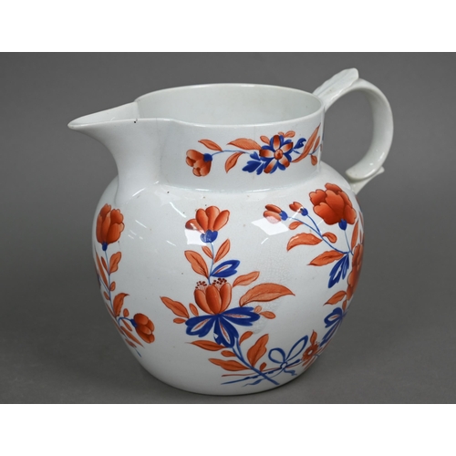 591 - An early 19th century stoneware large jug with floral painted decoration in iron red and blue enamel... 