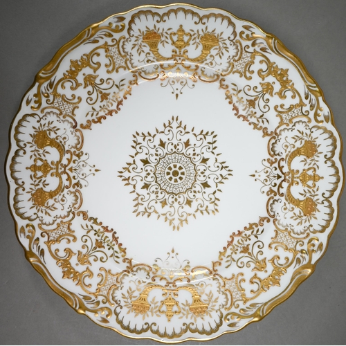 592 - A set of eleven Edwardian Coalport china 22.5 cm plates, finely gilded with cornucopiae, scrolls, fo... 