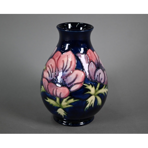 618 - A Walter Moorcroft 'Anenome' blue-ground vase, 19 cm high