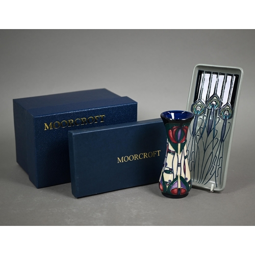 651 - A boxed Moorcroft 'Peacock Parade' pin-tray by Nicola Slaney, 2012, 20 x 9 cm to/w a boxed 'Mackinto... 