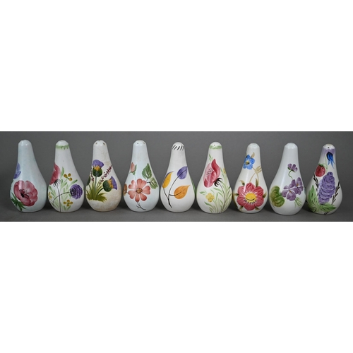 658 - A selection of E Radford floral-painted condiments, including salts, peppers and oil-ewers, to/w oth... 