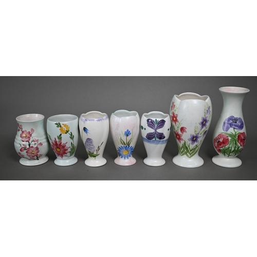 658 - A selection of E Radford floral-painted condiments, including salts, peppers and oil-ewers, to/w oth... 