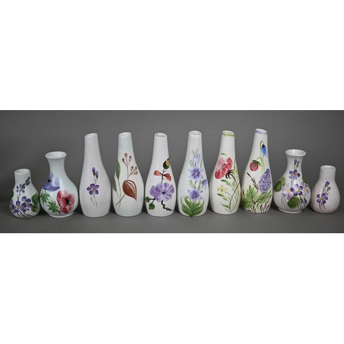 658 - A selection of E Radford floral-painted condiments, including salts, peppers and oil-ewers, to/w oth... 