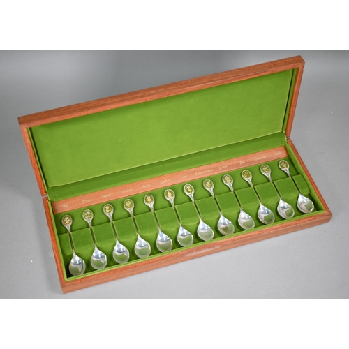 66 - A teak-cased set of twelve Royal Horticultural society Flower Spoons, the finials with inset gilt me... 