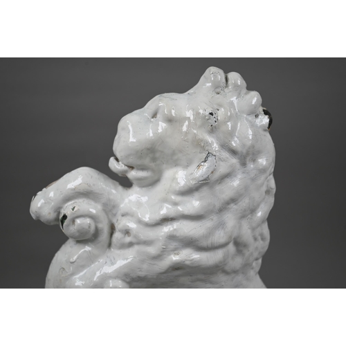 70 - A cast iron Victorian door stop modelled as a lion rampant, painted white, 37 cm