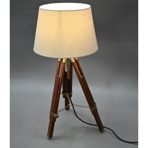 80 - A mid-20th century wooden and brass telescopic tripod converted to a table lamp, with an off-white c... 