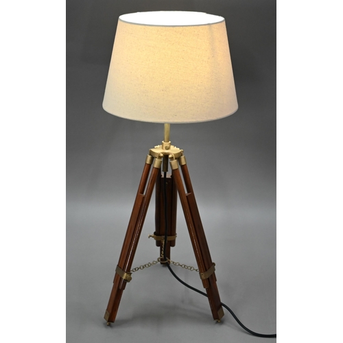 80 - A mid-20th century wooden and brass telescopic tripod converted to a table lamp, with an off-white c... 