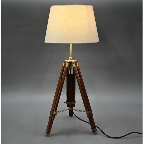 80 - A mid-20th century wooden and brass telescopic tripod converted to a table lamp, with an off-white c... 